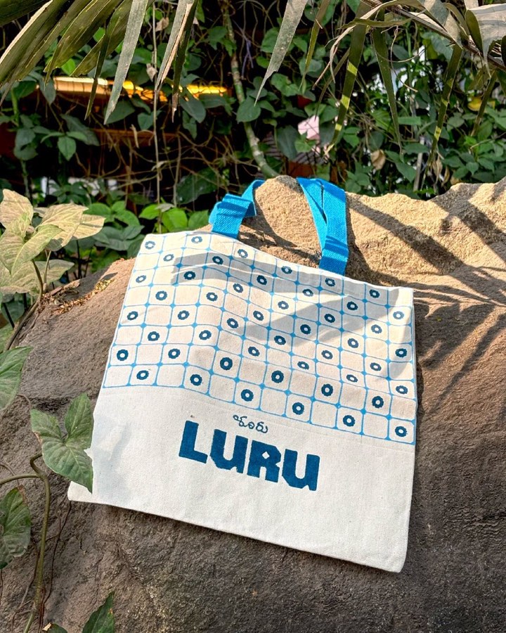 The Issue 02 tote: hand block-printed blue grid pattern on cream canvas with the LURU mark